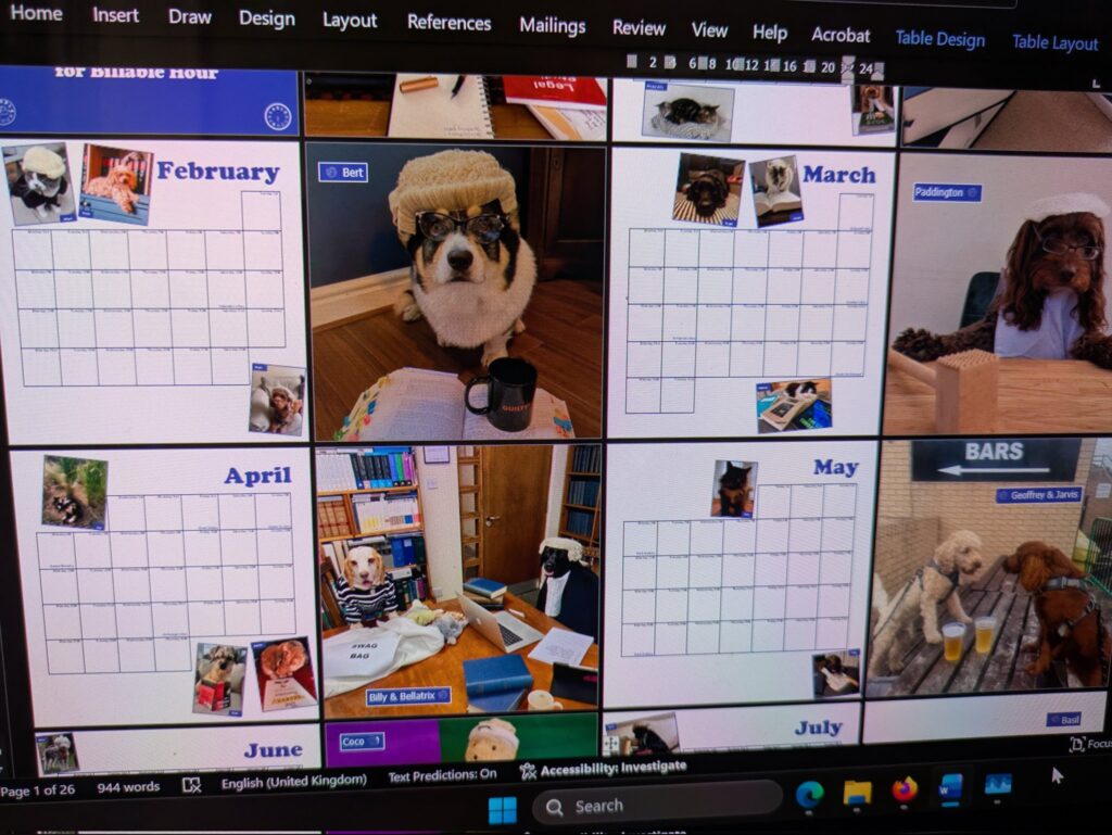 A calendar on a laptop screen. There are lots of pictures of pets in barrister wigs and law books